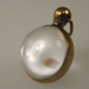 Gilt and glass ball locket c1890