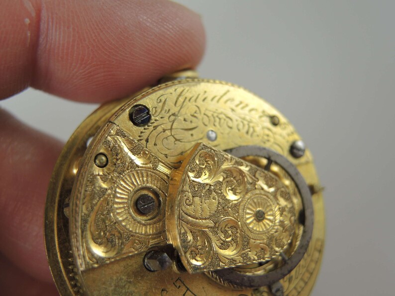 K&ouml;nnte beinhalten: Nahaufnahme einer goldenen Taschenuhr mit aufwendigen Gravuren und der Inschrift "J.  Yairden & Son London".