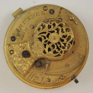 May include: A gold pocket watch with intricate floral engravings and the inscription "Artindell" and "Wm Lassetter".