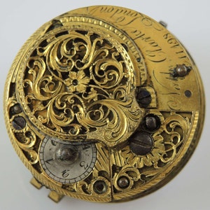 May include: A gold pocket watch with intricate floral engravings and the inscription "Thos. Clarke London 1728".