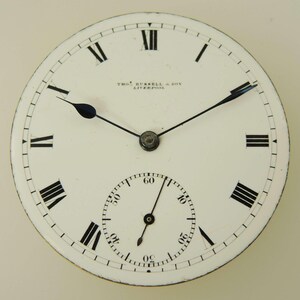 May include: A vintage pocket watch face with a white background, black Roman numerals, and black hands. The watch face has a smaller subdial at the bottom and the text "THOS. RUSSELL & SON LIVERPOOL" is printed at the top.