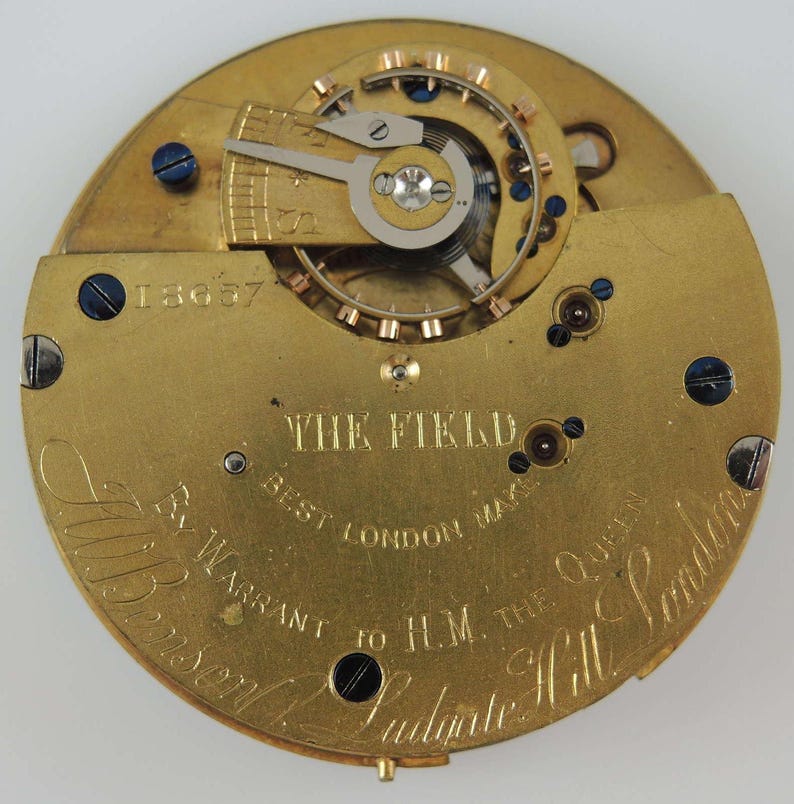 May include: A gold pocket watch movement with the inscription "The Field Best London Maker By Warrant to H.M. The Queen" and the number "18637".
