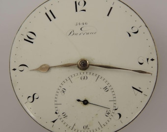 May include: Antique watch face with a cream-colored background, black Roman numerals, and delicate gold-toned hands. The face includes a smaller subdial and the name "Barrane" in cursive script. The watch face has a diameter of approximately 2 inches.