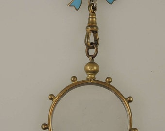 Victorian gilt metal and enamel bow pin with frame locket c1890