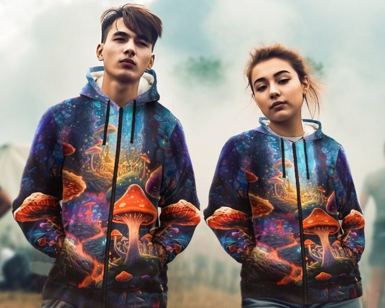 May include: Two people wearing black zip-up hoodies with a psychedelic mushroom print. The print features a variety of colorful mushrooms, glowing lights, and a dark blue background.