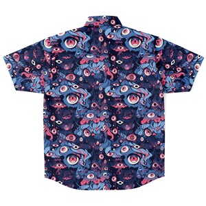 May include: A blue short-sleeved button-down shirt with a psychedelic print of pink and blue eyes. The shirt has a classic fit and a pointed collar.