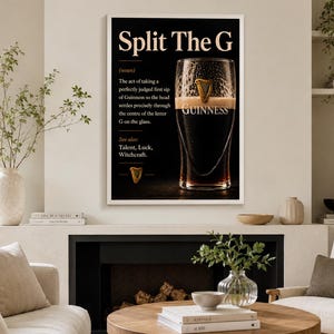 May include: A framed black and white print featuring a pint of Guinness. The text reads "Split The G" with a definition and the word "Guinness" below the glass. The print includes a gold harp symbol.