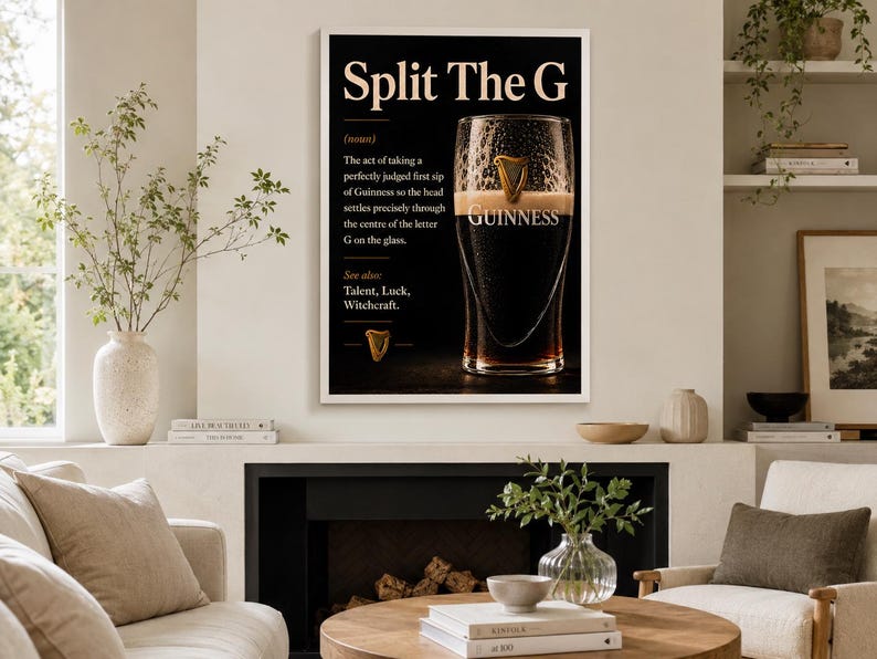 May include: A framed black and white print featuring a pint of Guinness. The text reads "Split The G" with a definition and the word "Guinness" below the glass. The print includes a gold harp symbol.