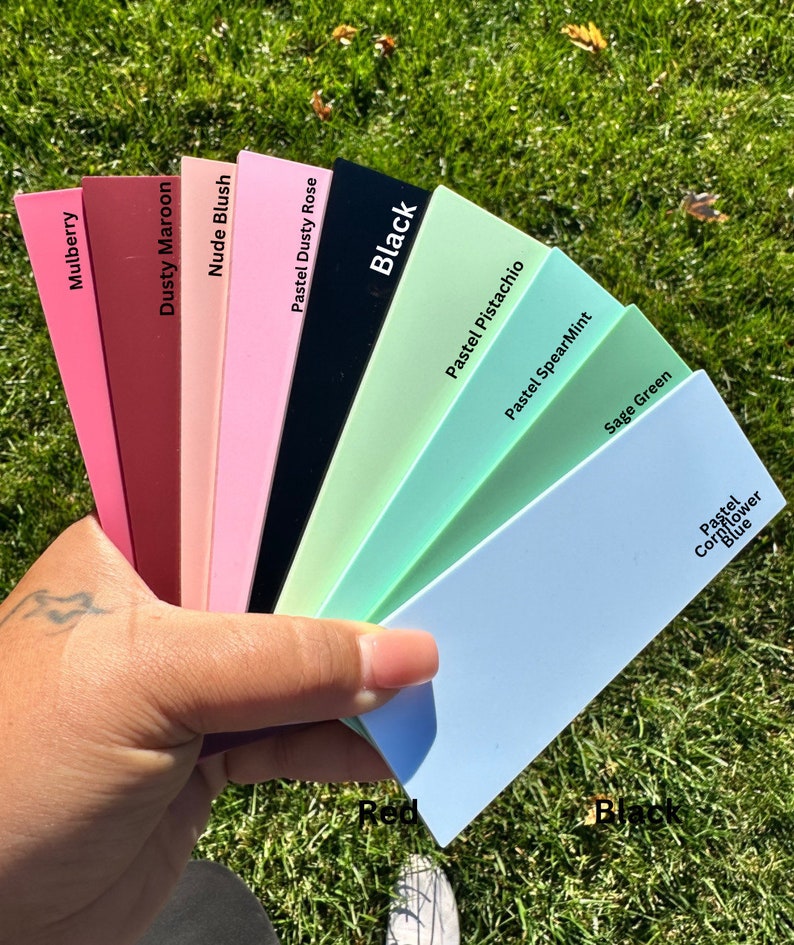 May include: A fan of color swatches in various shades of pink, green, blue, and red. The swatches are labeled with names like "Mulberry", "Dusty Maroon", "Nude Blush", "Pastel Dusty Rose", "Black", "Pastel Pistachio", "Pastel SpearMint", "Sage Green", and "Pastel Cornflower Blue".