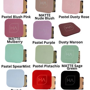 May include: A collection of 12 square matte nail polish colors, including pastel blush pink, nude blush, pastel dusty rose, matte mulberry, pastel purple, dusty maroon, pastel spearmint, pastel pistachio, matte sage green, pastel cornflower blue, red, and black.