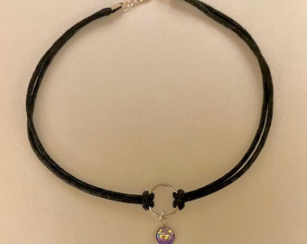 May include: A black choker necklace with a silver ring and a small iridescent purple pendant.