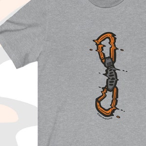 May include: A grey t-shirt with an orange and grey illustration of a climbing carabiner. The text "Athletic Heather" is at the top of the image.