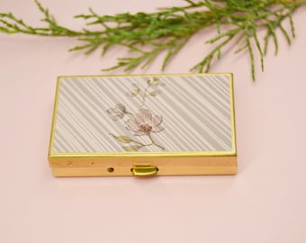 Gold pocket pill box with elegant and compact design