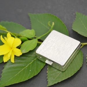 Gold pocket pill box with elegant and compact design