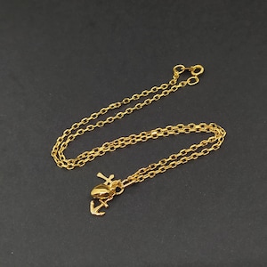Vintage gold necklace with cross, heart and anchor