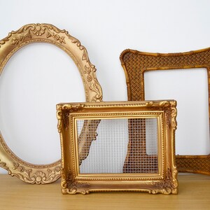May include: Three ornate gold picture frames, one oval, one square and one rectangular with a wire mesh insert.