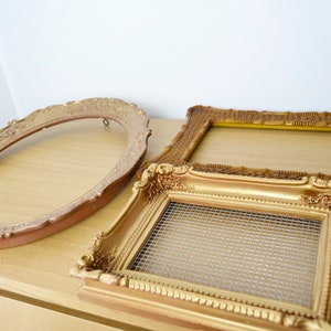 May include: Three gold picture frames, one oval, one rectangular and one square. The rectangular frame has a wire mesh insert.