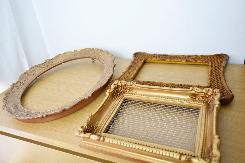 May include: Three gold picture frames, one oval, one rectangular and one square. The rectangular frame has a wire mesh insert.