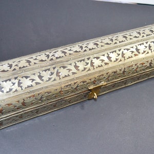 May include: A silver and brown rectangular box with intricate floral designs and a brass latch.