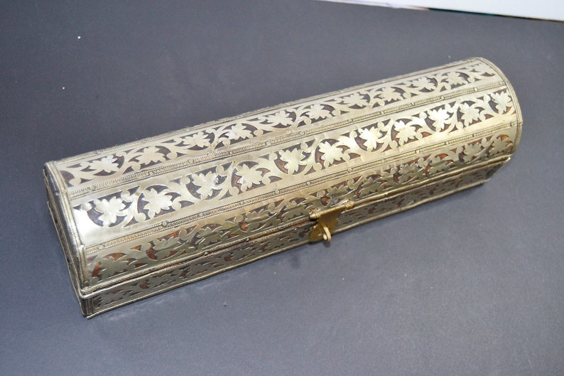 May include: A silver and brown rectangular box with intricate floral designs and a brass latch.