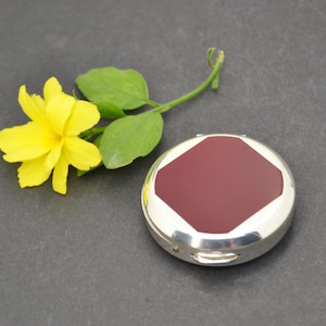 Gold pocket pill box with elegant and compact design