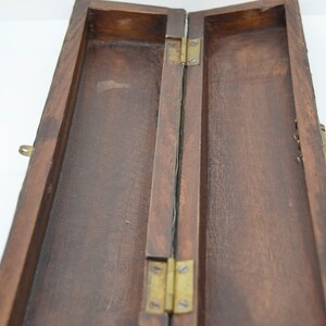 May include: A wooden box with a brass latch and hinges. The box is open and the inside is empty.