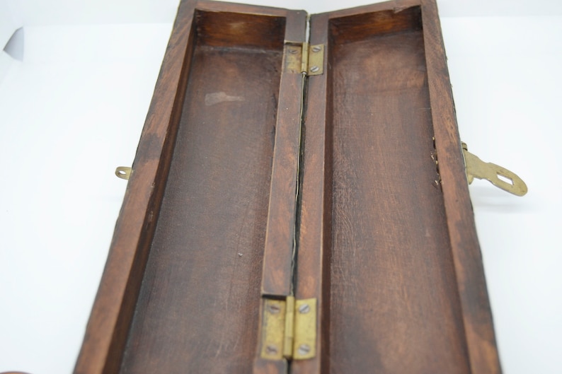 May include: A wooden box with a brass latch and hinges. The box is open and the inside is empty.
