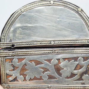 May include: A small, wooden box with intricate silver filigree designs. The box is hinged and has a silver-plated interior.