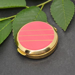 Gold pocket pill box with elegant and compact design