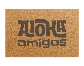 May include: A brown coir doormat with the text "ALOHA amigos" in black lettering.