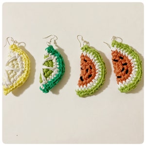 May include: Four crocheted fruit earrings, including a lemon, lime, and two watermelon slices. The earrings are made with green, white, yellow, and orange yarn.