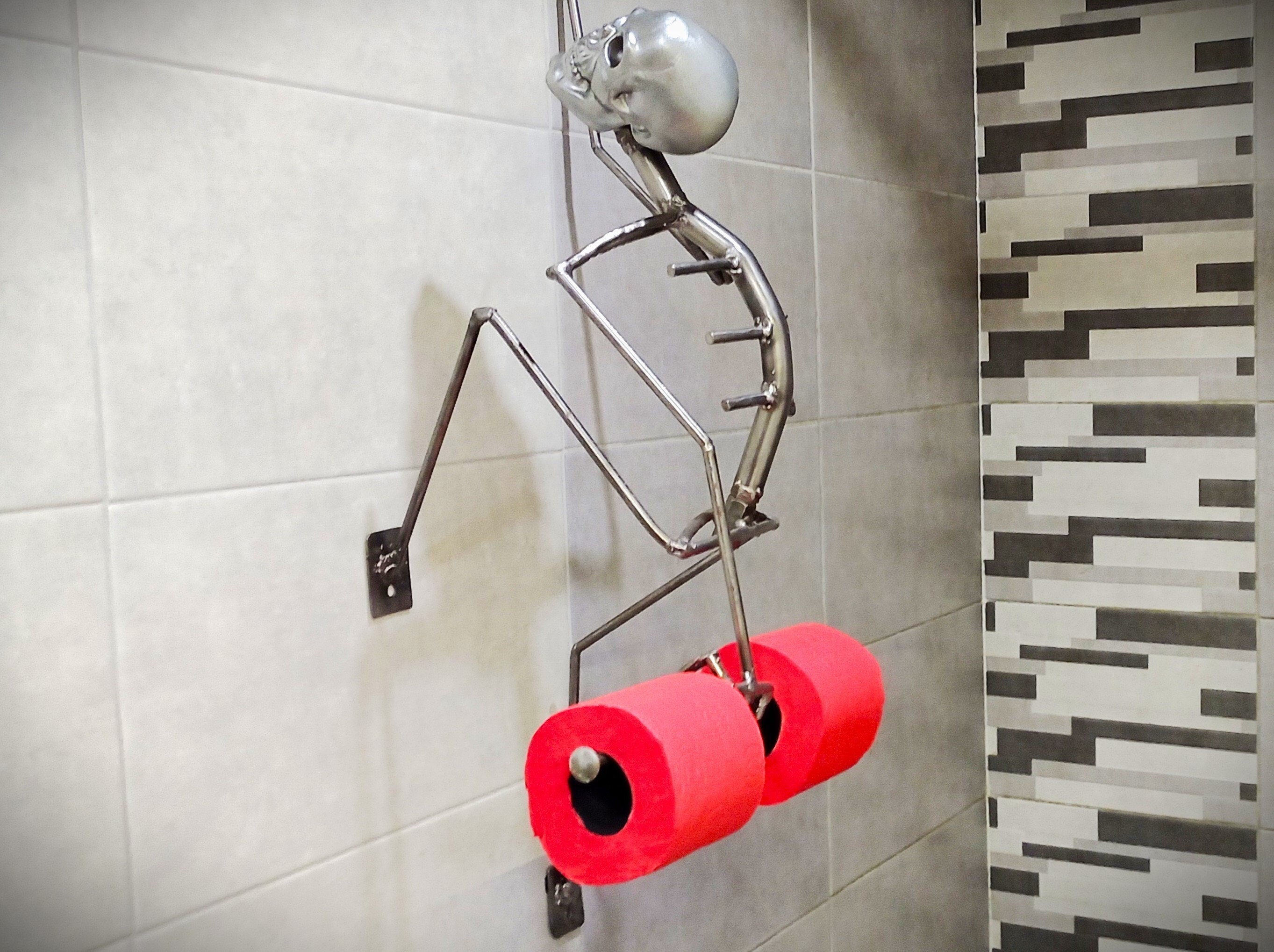 This Creepy Metal Skeleton Toilet Paper Holder Is Perfect For