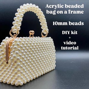 May include: An off-white acrylic beaded bag on a frame. The bag features a rectangular shape with a curved handle and a gold-colored clasp. The beads are 10mm in size. The image also includes text that says "DIY kit + video tutorial."