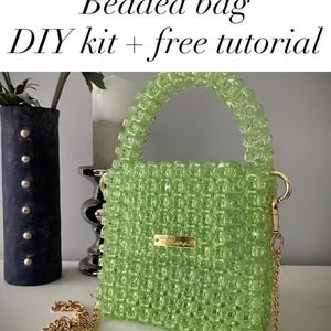 May include: A lime green beaded bag with a structured square shape, a top handle, and a gold-tone metal chain strap. The bag features a small rectangular gold-tone metal plaque on the front. The text "Beaded bag DIY kit + free tutorial" is visible.