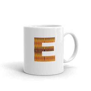 May include: White ceramic mug with a letter "E" printed on it. The letter is in a yellow, orange, red, green, and black pattern.