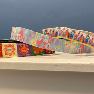 It&#39;s a Small World After All Non Slip Running Headbands with clock face and colorful buildings and hello and Goodbye signs