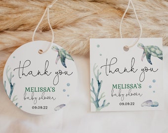 May include: Two round thank you tags with a watercolor sea turtle design. The text reads "Thank you Melissa's Baby Shower 09.09.22".