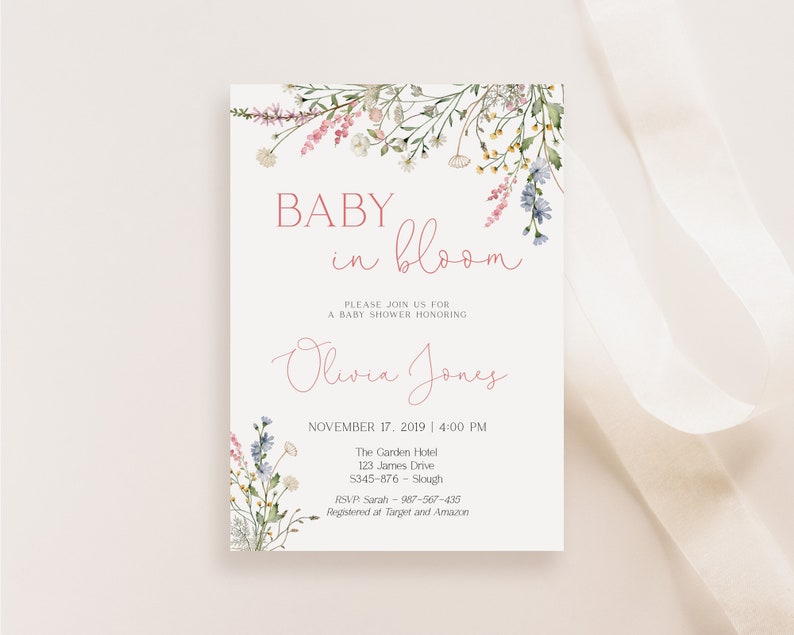 May include: A baby shower invitation with floral watercolor accents. The text reads "Baby in Bloom" and invites guests to celebrate Olivia Jones. The date and time are November 17, 2019, at 4:00 PM.