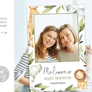 May include: A white photo booth frame with a green leafy border and watercolor illustrations of a giraffe, rhino, elephant, and lion. The frame has a space for a photo and text that says "Melissa's Baby Shower #yourtextthere".