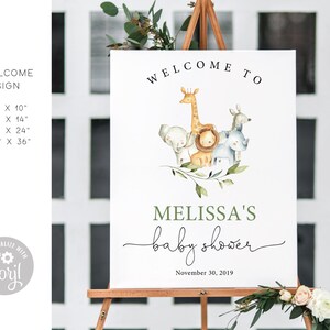May include: A white welcome sign with a green border and the text "Welcome to Melissa's baby shower" with a date of November 30, 2019. The sign features a watercolor illustration of a giraffe, elephant, lion, and rhinoceros.