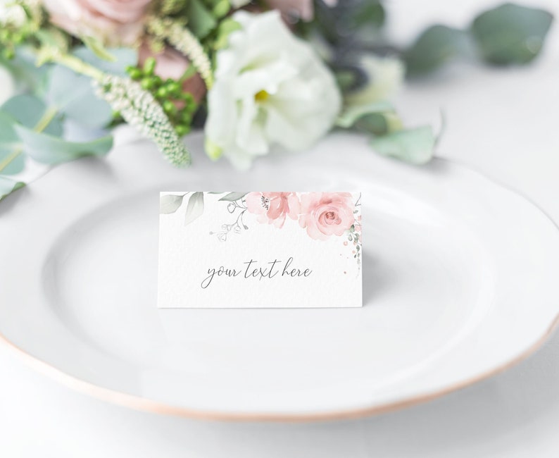 K&ouml;nnte beinhalten: Eine wei&szlig;e Tischkarte mit einem rosafarbenen Blumendesign und dem Text "your text here".