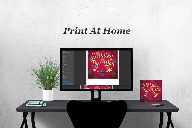 Wedding This Way print at home. A desk with a computer showing the file on a print screen and an example of a print to the left