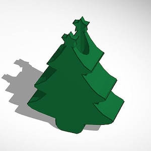 Op de afbeelding: Een groene kerstboomversiering met een ster bovenop. De versiering is gemaakt van plastic en heeft een gladde, glanzende afwerking.