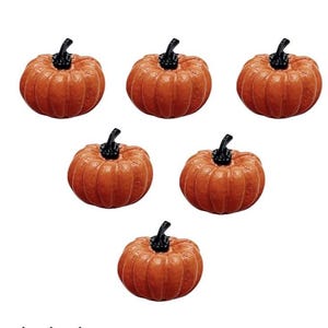 May include: Six miniature orange pumpkins with black stems are arranged against a white background. The pumpkins have a ribbed texture and are likely decorative items for fall or Halloween.