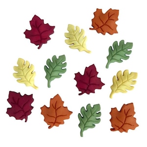 May include: Assortment of fall leaves in various colors, including red, orange, yellow, and green. The leaves are made of felt and are perfect for crafting or decorating.