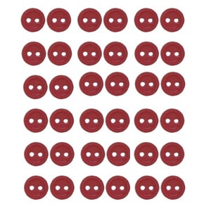 May include: A set of 40 red plastic buttons with two holes each. The buttons are arranged in a grid pattern.