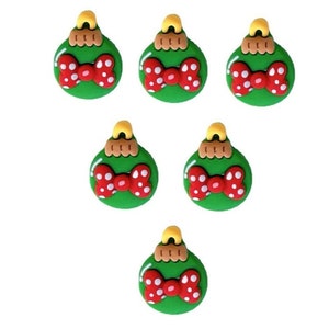 May include: Six green Christmas ornaments with a red bow with white polka dots. Each ornament has a gold top.