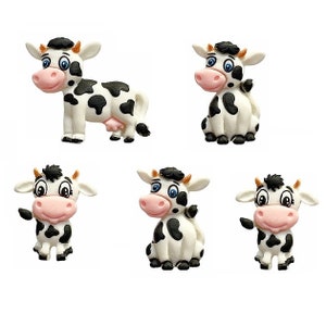 May include: Five black and white cartoon cow figurines. The cows are in various poses, including standing, sitting, and looking to the side. The cows have black spots on a white background.