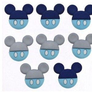 May include: Nine blue and gray felt Mickey Mouse head appliques with white eyes. The appliques are perfect for adding a touch of Disney magic to crafts and projects.