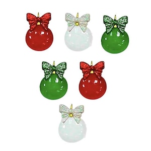 May include: A collection of Christmas ornaments in red, white, and green. Each ornament is a round ball with a glittery bow on top. The bows are red, green, and white. The ornaments are for decorating a Christmas tree.